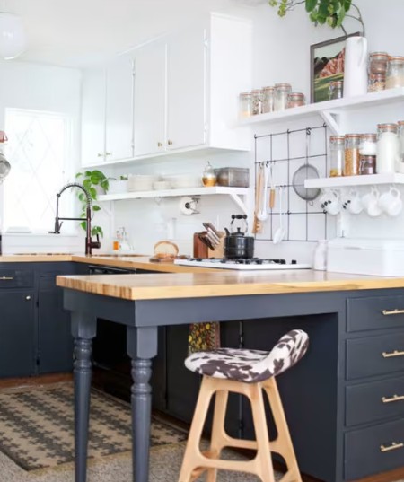 The same kitchen transformed with crisp white and deep navy hand-painted cabinets and wood worktops